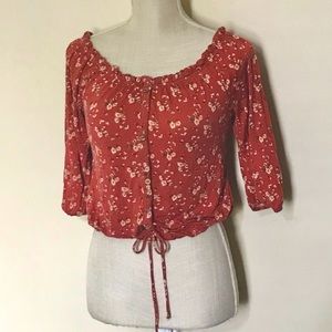 Orange floral blouse with tie in the front